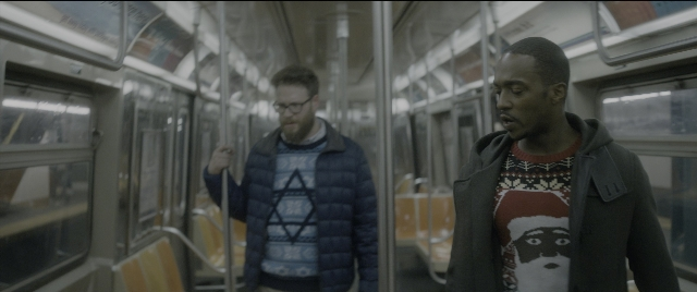 Wide shot frame from The Night Before — standing, hand, jacket