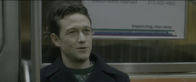 Medium shot frame from The Night Before — sitting, coat, face