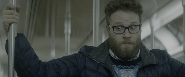 Medium shot frame from The Night Before — standing, hand, beard