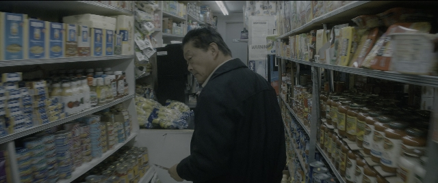 Wide shot frame from The Night Before — standing, food, person
