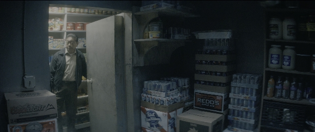 Medium shot frame from The Night Before — standing, room, shelf