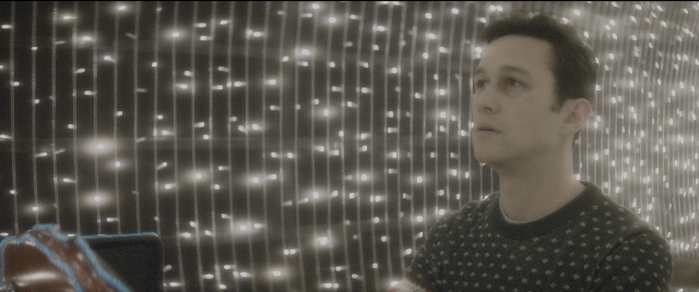 Wide shot frame from The Night Before — sitting, chair, face