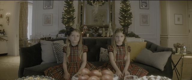 Wide shot frame from The Night Before — sitting, plate, room