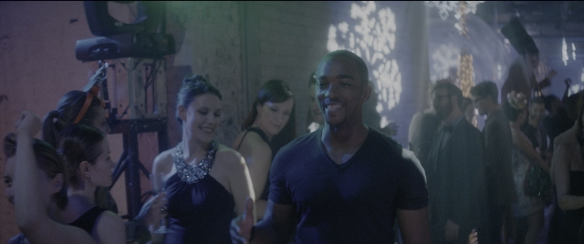 Wide shot frame from The Night Before — standing, room, dress