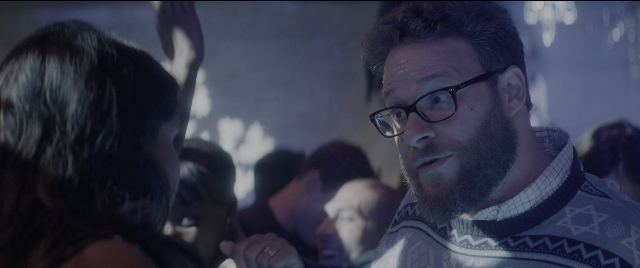 Wide shot frame from The Night Before — standing, room, dialogue