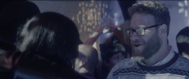 Medium shot frame from The Night Before — standing, room, dialogue