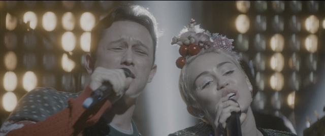 Medium shot frame from The Night Before — microphone, face, hair