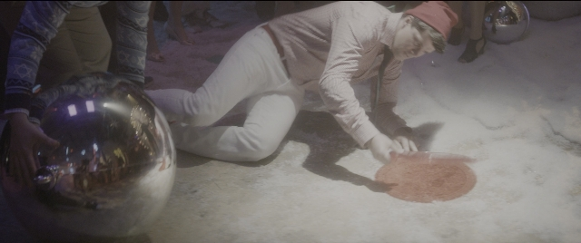 Frame from The Night Before — hand, shirt, person
