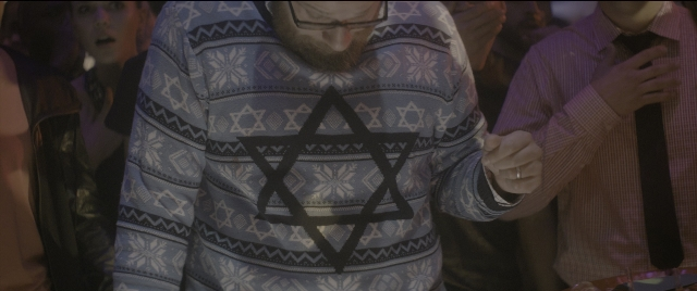 Wide shot frame from The Night Before — standing, room, hand