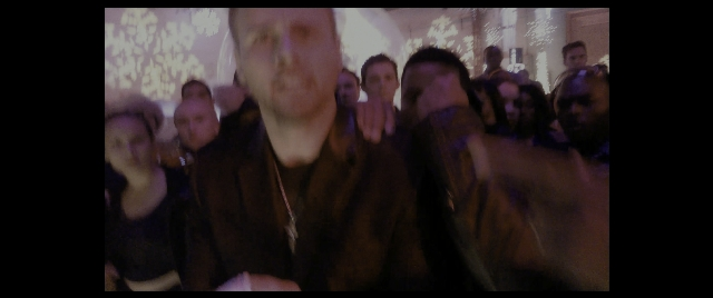 Wide shot frame from The Night Before — room, face, person