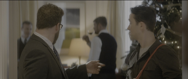 Wide shot frame from The Night Before — standing, room, dialogue