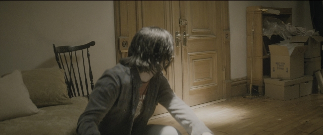 Wide shot frame from The Night Before — sitting, room, door