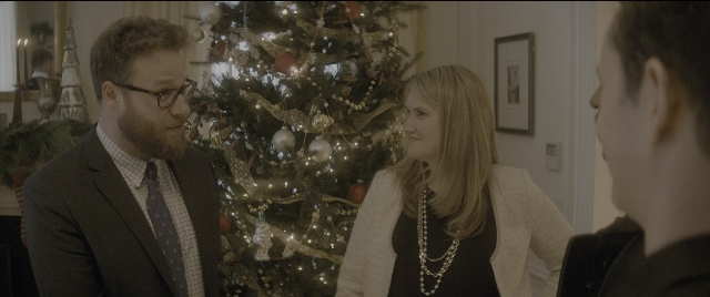 Wide shot frame from The Night Before — standing, room, suit