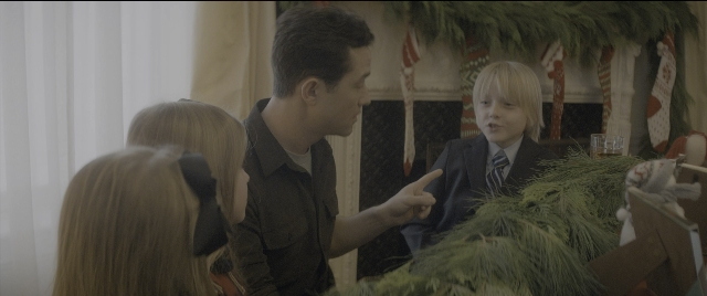 Wide shot frame from The Night Before — standing, dialogue, hand