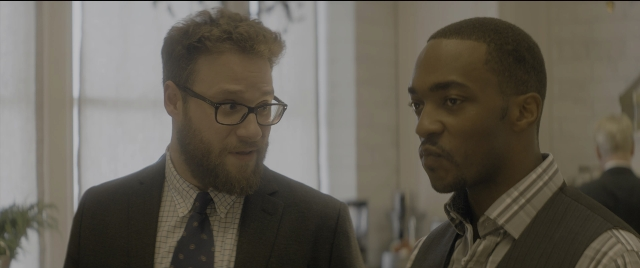 Medium shot frame from The Night Before — room, dialogue, suit