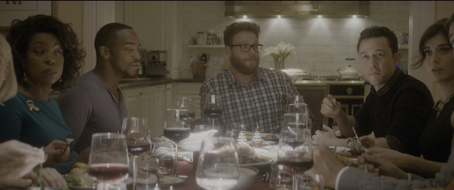 Wide shot frame from The Night Before — sitting, table, dialogue