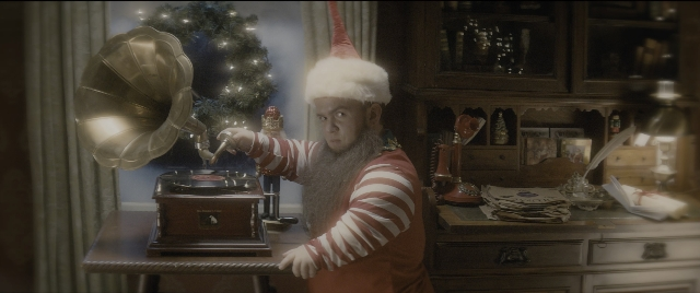 Wide shot frame from The Night Before — room, table, hat