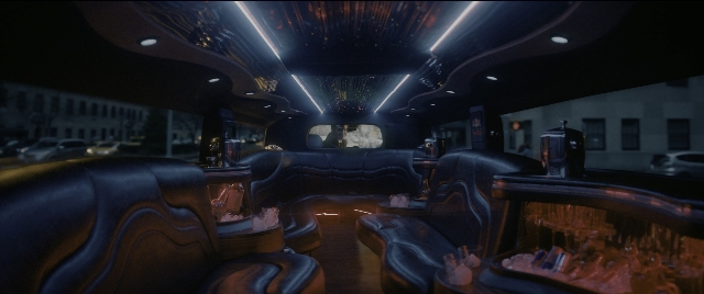 Wide shot frame from The Night Before — room, limousine, window