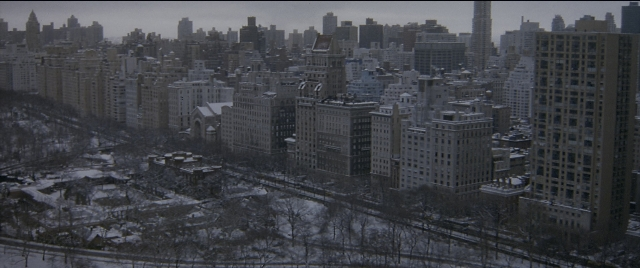 Wide shot frame from The Night Before — tower, skyscraper, train