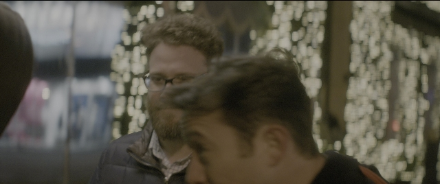Wide shot frame from The Night Before — standing, beard, face