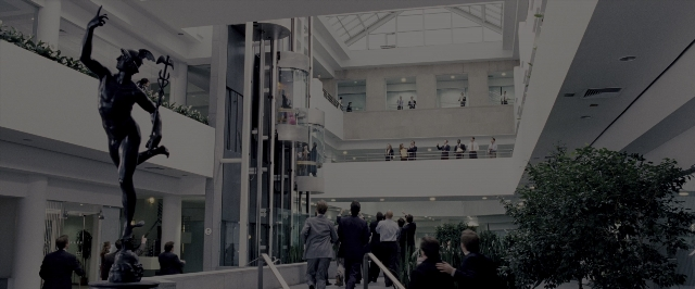 Wide shot frame from The Wolf of Wall Street — standing, walking, hand