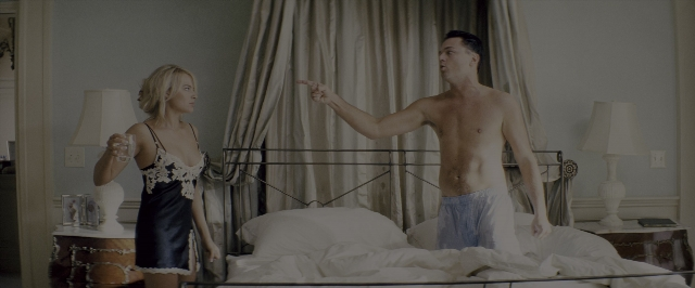 Wide shot frame from The Wolf of Wall Street — standing, room, bed