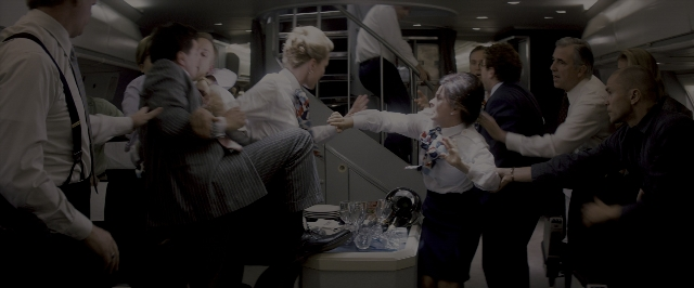 Wide shot frame from The Wolf of Wall Street — plate, hand, suit