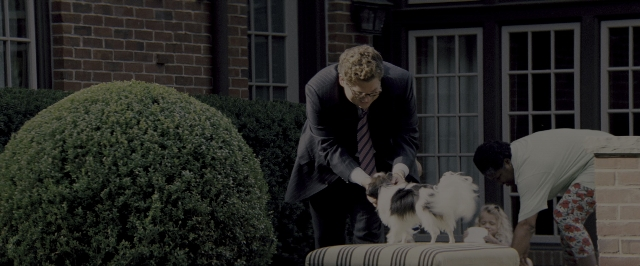 Wide shot frame from The Wolf of Wall Street — table, dog, suit