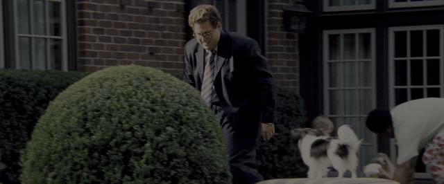 Wide shot frame from The Wolf of Wall Street — standing, walking, table
