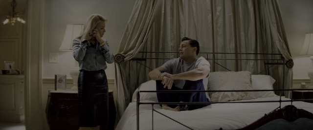Wide shot frame from The Wolf of Wall Street — sitting, standing, room