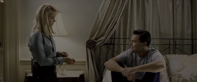Wide shot frame from The Wolf of Wall Street — sitting, standing, room