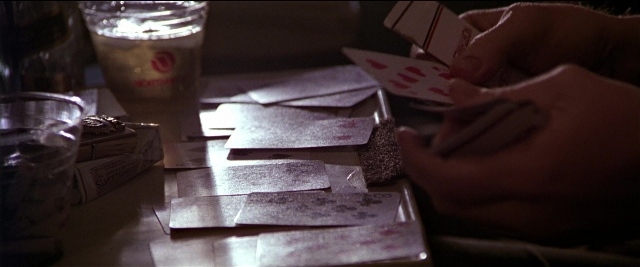 Wide shot frame from Black Rain — room, table, hand