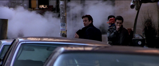 Wide shot frame from Black Rain — standing, street, hat
