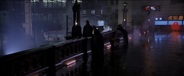 Wide shot frame from Black Rain — standing, walking, street
