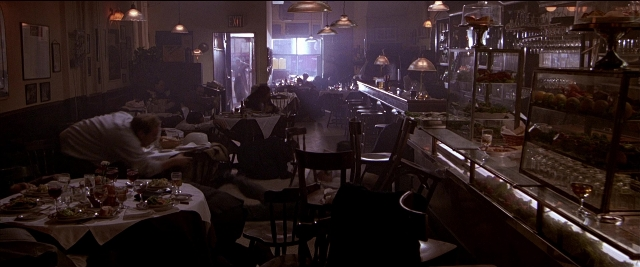 Wide shot frame from Black Rain — sitting, room, table