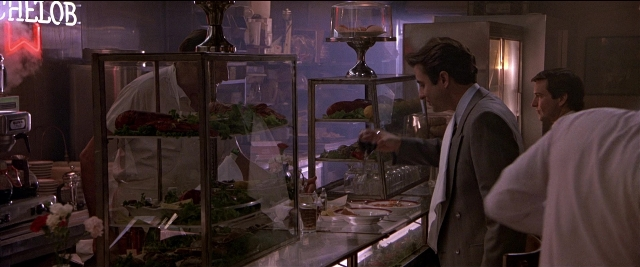 Wide shot frame from Black Rain — standing, table, food
