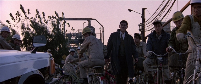 Wide shot frame from Black Rain — standing, street, car