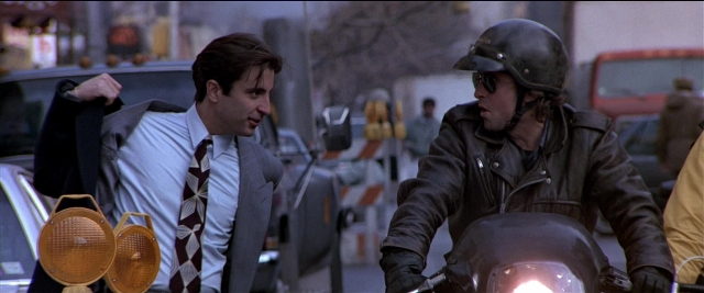 Wide shot frame from Black Rain — dialogue, street, suit