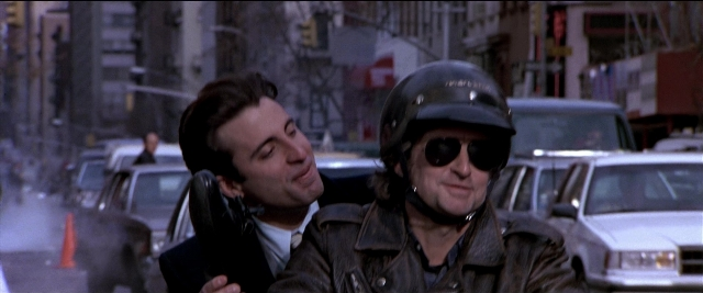 Wide shot frame from Black Rain — dialogue, phone, street