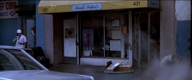 Frame from Black Rain — standing, phone, door
