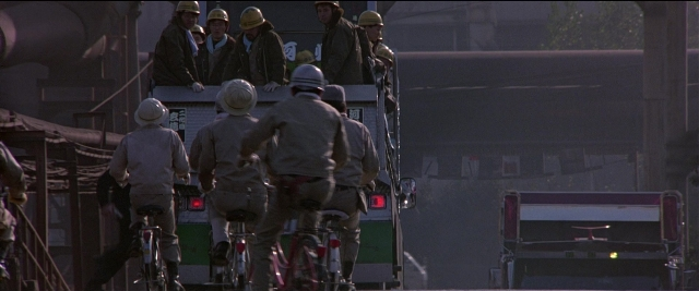 Wide shot frame from Black Rain — street, fire, night