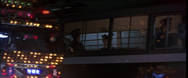 Frame from Black Rain — standing, street, night