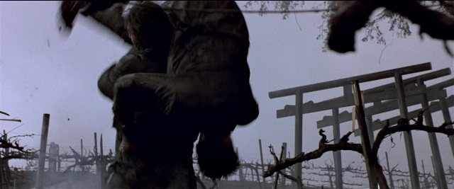 Frame from Black Rain — hand, forest, person