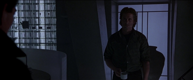 Wide shot frame from Black Rain — standing, room, table
