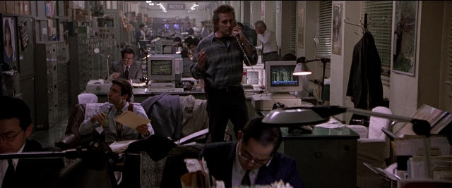 Wide shot frame from Black Rain — sitting, book, standing