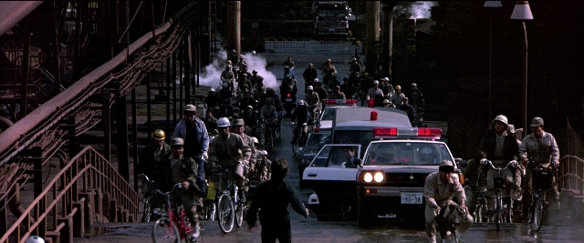 Wide shot frame from Black Rain — street, car, night