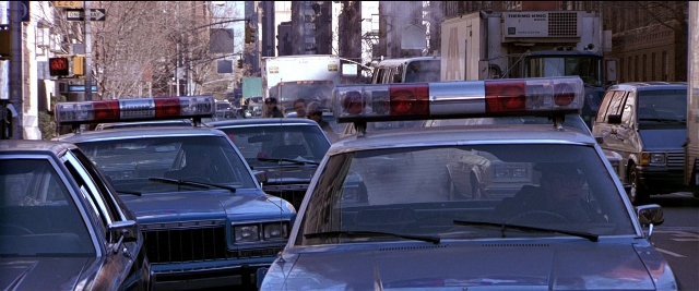 Wide shot frame from Black Rain — street, car, wheel