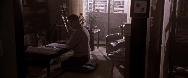 Frame from Black Rain — sitting, room, couch