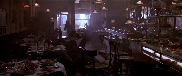 Wide shot frame from Black Rain — sitting, room, table
