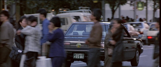 Wide shot frame from Black Rain — standing, walking, plate